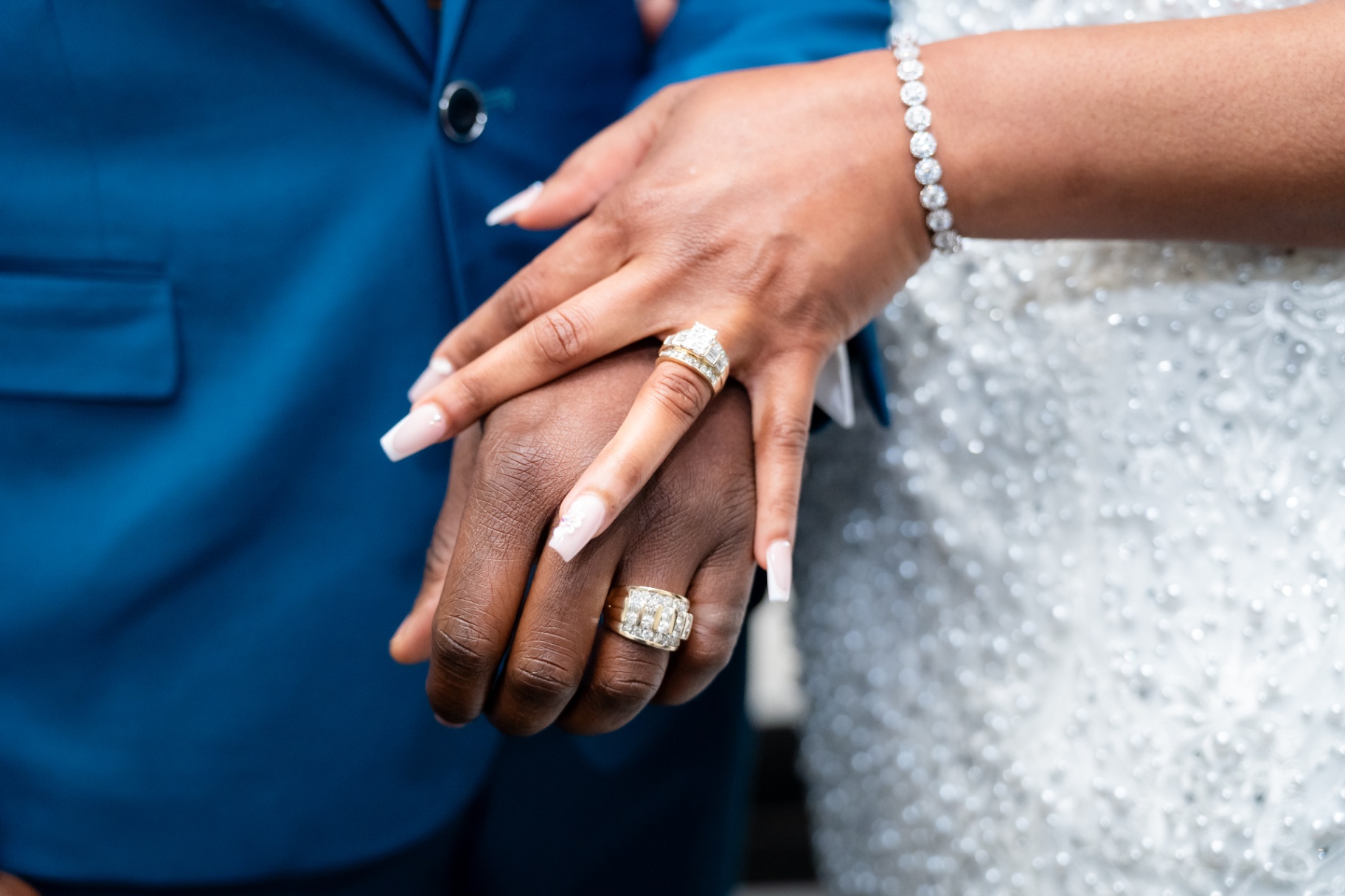 Bride and groom hands with wedding rings