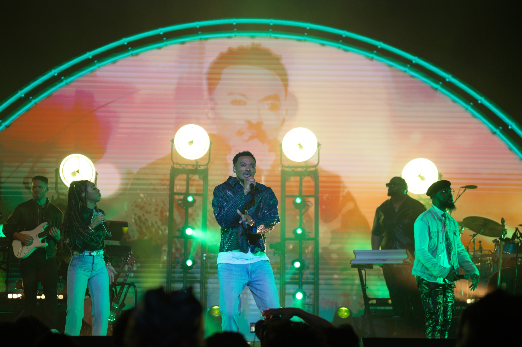Artist performing under arched LED stage
