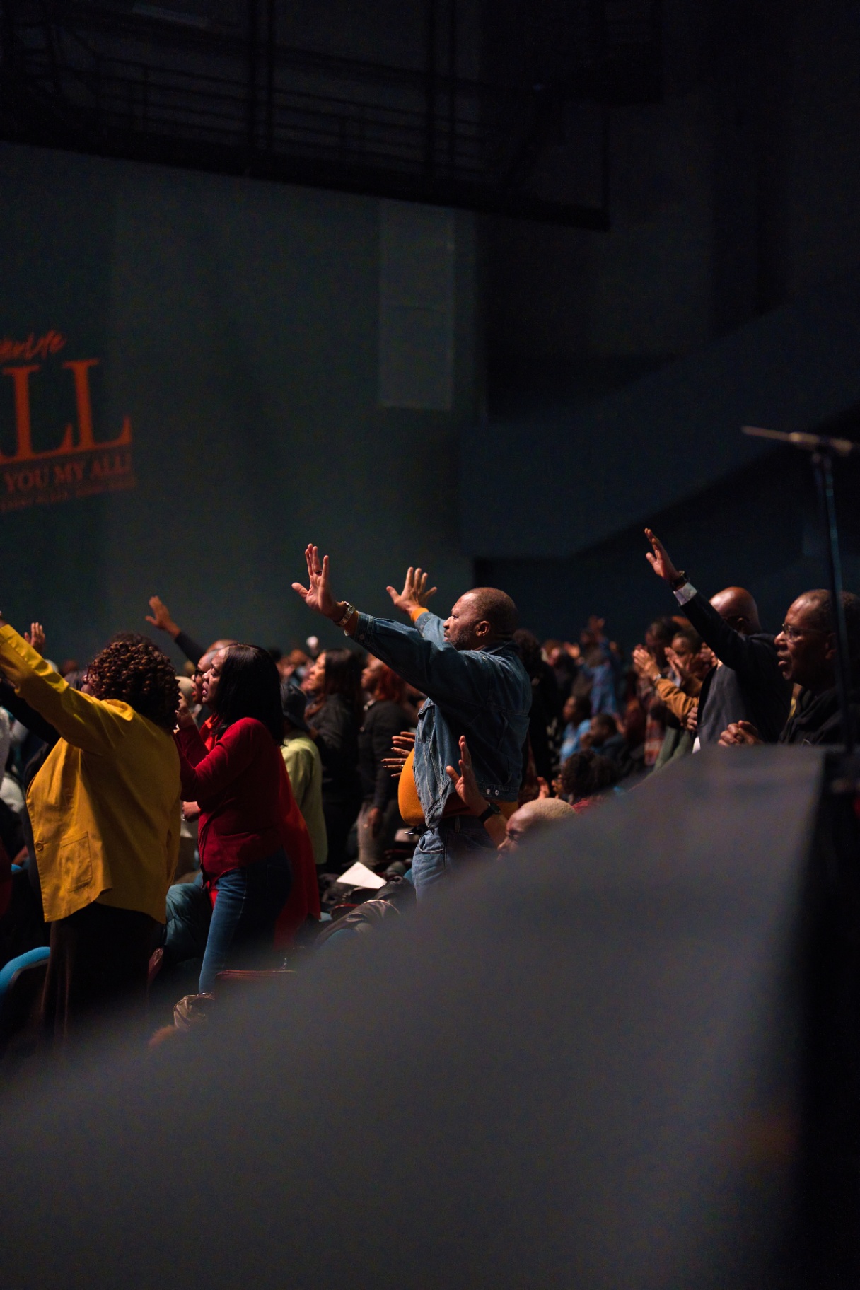 Congregation lifting hands during worship service