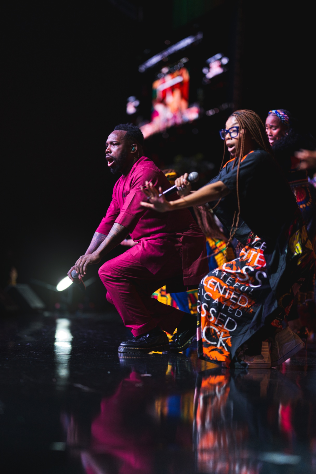 Worship leaders performing on stage in vibrant attire